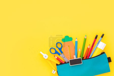 Photo for School supplies  in case on yellow background.   Back to school. Flat lay. - Royalty Free Image