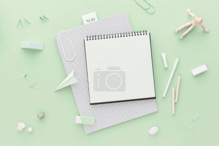 Photo for Notepads on green background and   school supplies.   Back to school. Flat lay. - Royalty Free Image