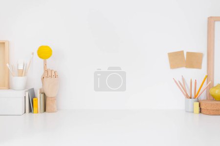 Photo for Home workspace, creative desk with wooden supplies and wall. - Royalty Free Image