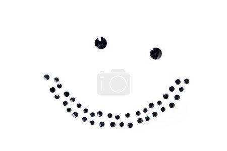 Lopsided smile face made of round black dots isolated over white