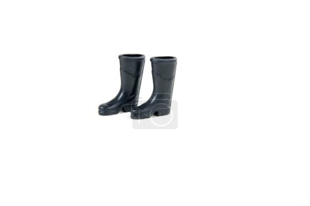 Pair of black rubber doll boots isolated over white side view