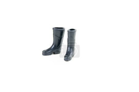 Pair of black rubber doll boots isolated over white