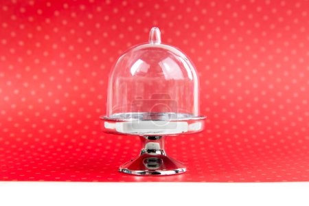 Toy cake stand display over a red background side view