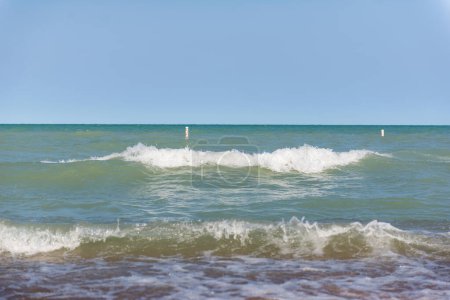 Beach near Lake Michigan. Rough waves. Two waves on the water.