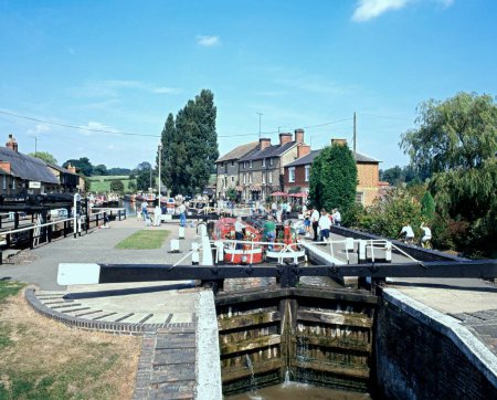 Photo for STOKE BRUERNE, UK - AUGUST 29, 1993 - Narrow boats passing through the lock on the Grand Union canal, Stoke Bruerne, UK, August 29, 1993 - Royalty Free Image