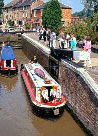Photo for STOKE BRUERNE, UK - AUGUST 29, 1993 - Narrow boats passing through a lock on the Grand Union canal, Stoke Bruerne, UK, August 29, 1993 - Royalty Free Image