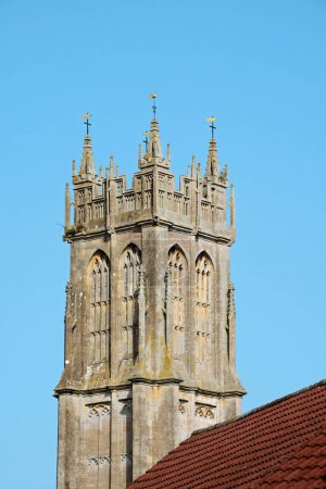 View of St John the Baptist church tower along High Street, Glastonbury, Somerset, UK, Europe
