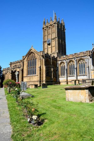 Front view of St Marys Minster Church in the town centre with the graveyard in the foreground, Ilminster, Somerset, UK, Europe