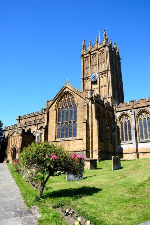 Front view of St Marys Minster Church in the town centre with the graveyard in the foreground, Ilminster, Somerset, UK, Europe