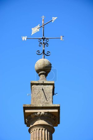 View of the top part of the Market Cross (also known as the Pinnacle Monument) along Church street in the town centre, Martock, Somerset, UK, Europe