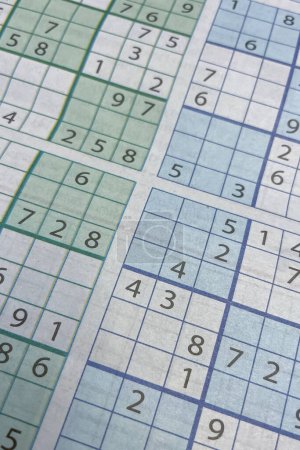 Photo for Close-up of a table with numbers and a crossword puzzle. Sudoku. - Royalty Free Image