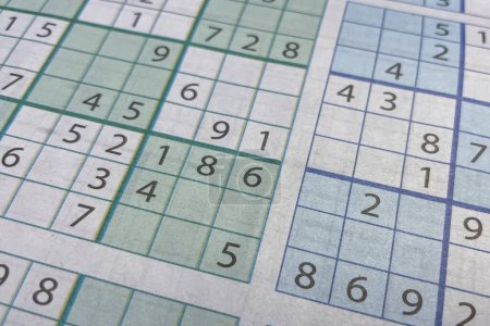 Close-up of a table with numbers and a crossword puzzle. Sudoku.