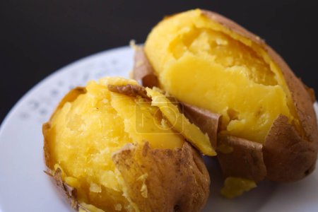 Photo for Close-up of boiled whole potatoes in the plate,boiled large potatoes with the peel, - Royalty Free Image