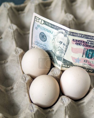 Photo for There are eggs in the egg carton and 100 dollars on it, implying an increase in egg prices, - Royalty Free Image