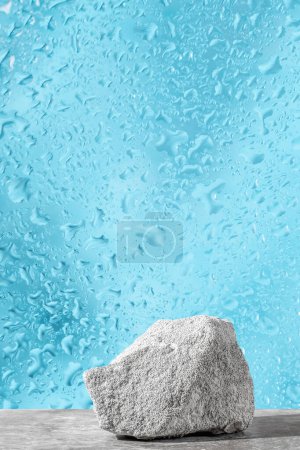 Podium texture stone for presentation on a blue dewy background. still life for layout. Copy space