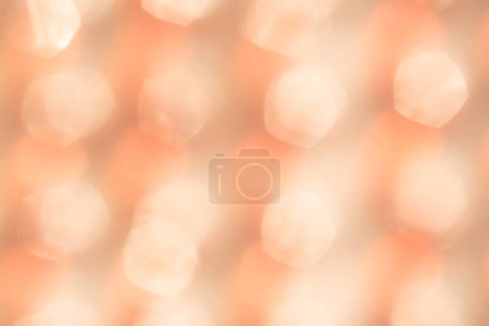 Blurred pastel orange-peach background. trendy color 2024 Peach Fuzz, bokeh