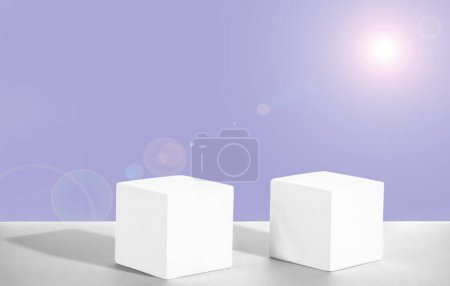  Two cement cubic podiums against on a soft lilac gradient background. Mockup for the demonstration of cosmetic products. Copy space