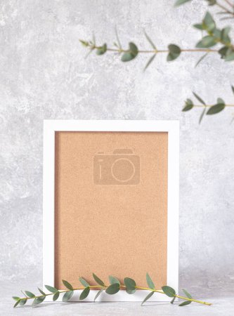 Blank photo frame and flowers hellebores. Floral background. copy space. Vertical photo