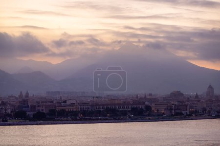 City on Mediterranean Coast with mountains in background in Palermo, Sicily, Italy. Sunset Sky.