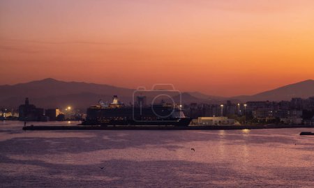 Photo for Cruise Ship in Port in Capital City of Athens, Greece. Colorful Sunrise Sky. - Royalty Free Image