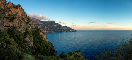 Photo for Touristic Town, Positano, on Rocky Cliffs and Mountain Landscape by the Tyrrhenian Sea. Amalfi Coast, Italy. Sunset Sky Panorama - Royalty Free Image