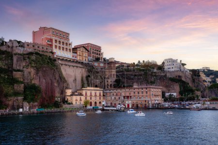 Photo for Homes and Hotels in a touristic town on the seafront. Sorrento, Compania, Italy. Colorful Sunrise Sky Art Render. - Royalty Free Image