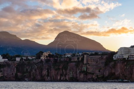 Photo for Homes and Hotels in a touristic town on the seafront. Sorrento, Compania, Italy. Colorful Sunrise Sky Art Render. - Royalty Free Image