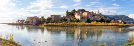 Photo for Old Residential Homes near river and sea in Ventimiglia, Italy. Sunny Fall Season. Day time. Panorama - Royalty Free Image