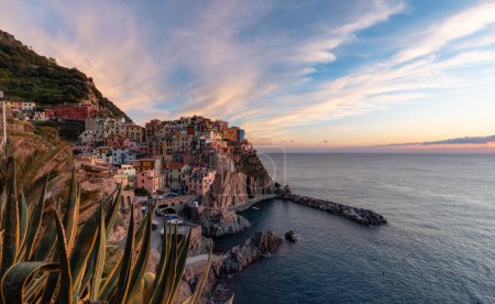 Foto de Small touristic town on the coast, Manarola, Italy. Cinque Terre. Colorful Sunny Sunset Fall Season. - Imagen libre de derechos