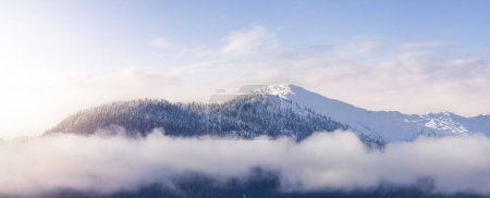 Photo for Snow and Cloud covered Canadian Nature Landscape Background. Winter Season in Squamish, British Columbia, Canada. Sunset Sky Art Render - Royalty Free Image