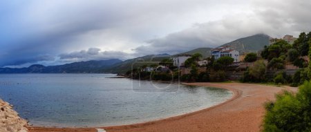 Photo for Panoramic View of Sandy Beach in Cala Gonone, Sardinia. Cloudy Sunrise Sky. - Royalty Free Image