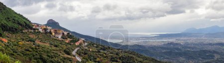 Téléchargez les photos : Small Touristic Town, Baunei, in the Mountains of Sardinia, Italy. Cloudy Rainy Day. Fall Season. Panorama - en image libre de droit