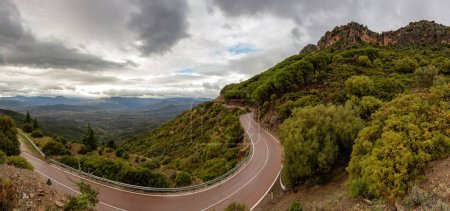 Foto de Scenic Highway, Orientale Sarda, in the mountain landscape. Cloudy Rainy Day. Sardinia, Italy. Panorama - Imagen libre de derechos