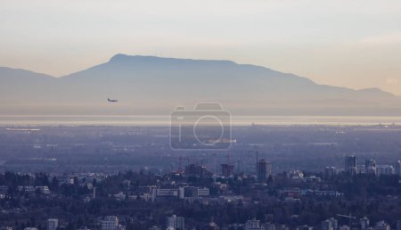 Photo for Buildings in Vancouver City, BC, Canada. Mountains in Background. Sunny winter sunset. - Royalty Free Image