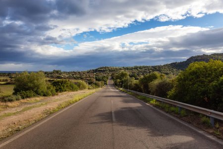 Téléchargez les photos : Scenic Road near a town by the Sea. Costa Rei, Sardinia, Italy. Sunny Cloudy Day. - en image libre de droit