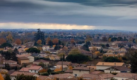 Photo for Small old town and Residential homes in Mauves, France. Cloudy Moody Sunset Sky. - Royalty Free Image