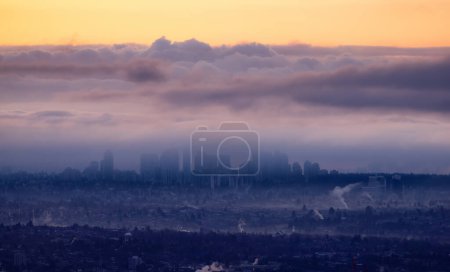 Photo for Metrotown City viewed from Cypress Lookout. Cloudy and Foggy Sunrise. Vancouver, British Columbia, Canada. - Royalty Free Image