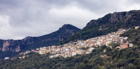 Téléchargez les photos : Small Touristic Town, Baunei, in the Mountains of Sardinia, Italy. Cloudy Rainy Day. Fall Season - en image libre de droit