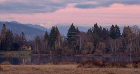 Photo for Deer Lake Park with mountains in background. Burnaby, Vancouver, BC, Canada. Colorful Winter Sunset Sky. - Royalty Free Image