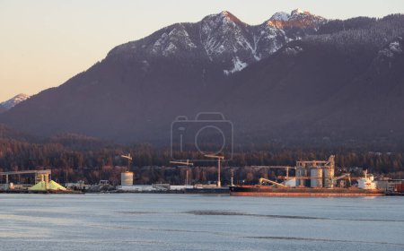 Photo for Industrial Sites in Vancouver Harbour with Mountains in Background. Vancouver, British Columbia, Canada. Sunrise - Royalty Free Image