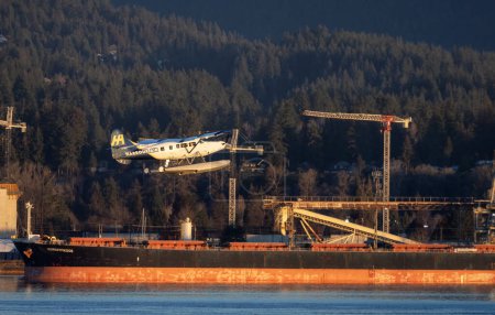 Photo for Vancouver, British Columbia, Canada - January 29, 2023: Harbour Air Float Airplane taking off from Vancouver Harbour Airport during winter Sunrise. - Royalty Free Image