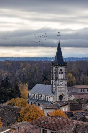 Foto de Small old town and Church in Mauves, France. Cloudy Moody Sunset Sky. - Imagen libre de derechos
