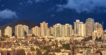 Photo for Residential Homes and Buildings in Modern City. Mountains in Background. North Vancouver, British Columbia, Canada. - Royalty Free Image