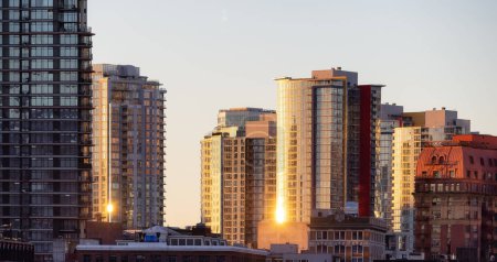 Photo for Residential Highrise Apartment Buildings in Coal Harbour, Downtown Vancouver, British Columbia, Canada. Winter Sunrise - Royalty Free Image