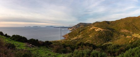 Téléchargez les photos : Rocky Coast by the Sea. Sardinia, Italy. Nature Background. Cloudy Sunset Sky. Panorama - en image libre de droit