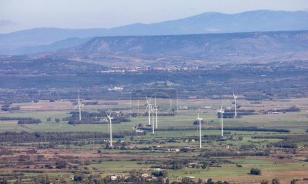 Photo for Wind Turbines and Famrs near Small Town in the Countryside, Guspini, Sardinia, Italy. Sunny Fall Season Day. - Royalty Free Image