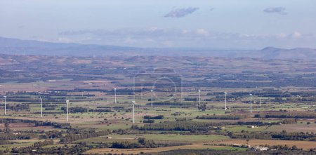 Photo for Wind Turbines and Famrs near Small Town in the Countryside, Guspini, Sardinia, Italy. Sunny Fall Season Day. - Royalty Free Image