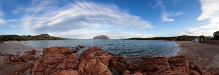 Téléchargez les photos : Rocky and Sandy Beach in Porto Istana, Sardinia, Italy. Tavolara Island in Background. Nature Panorama - en image libre de droit
