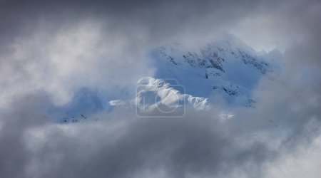 Photo for Tantalus Range covered in Snow and Clouds during Winter Season. Near Whistler and Squamish, British Columbia, Canada. Nature Background - Royalty Free Image