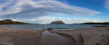 Téléchargez les photos : Rocky and Sandy Beach in Porto Istana, Sardinia, Italy. Tavolara Island in Background. Nature Panorama - en image libre de droit
